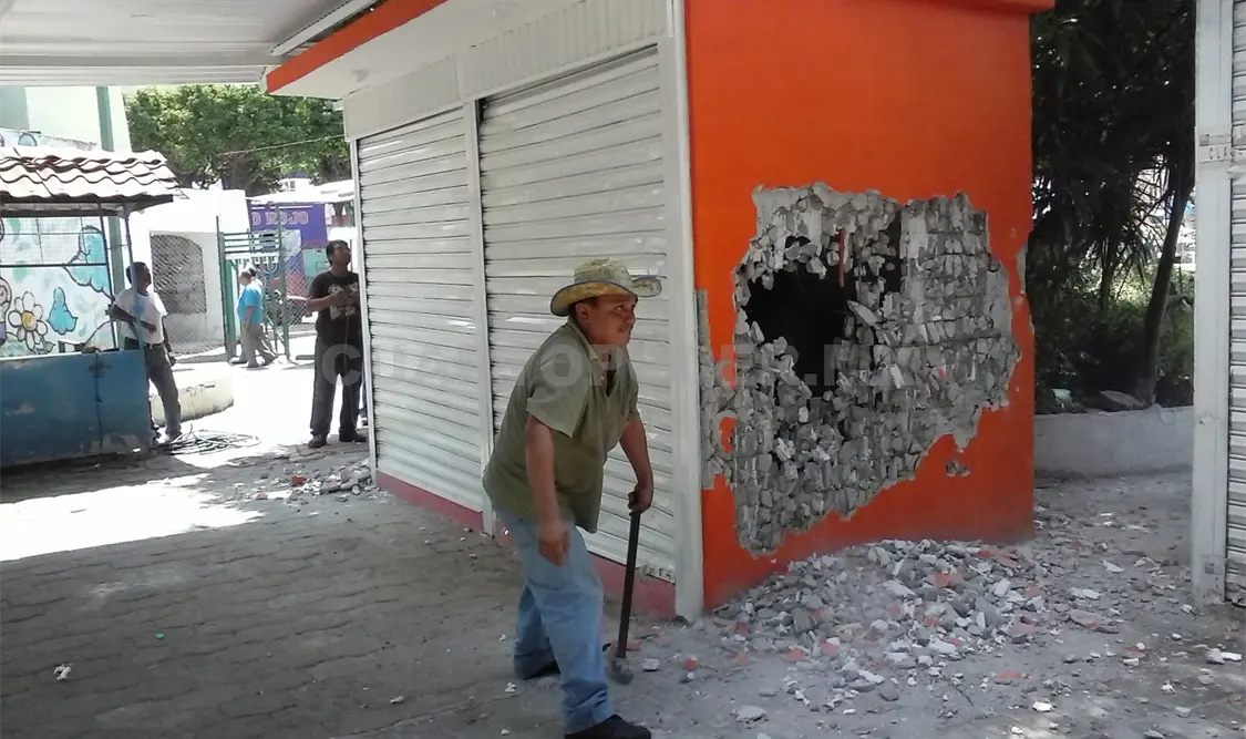 A golpe de marro artesanos del Rincón del Arte y vendedores de fayuca Tepituxtla derriban un local comercial a un particular. Sergio Granda / CP