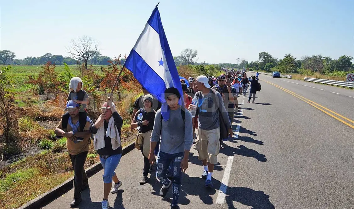 Cruza caravana de migrantes por el puente, otros son registrados