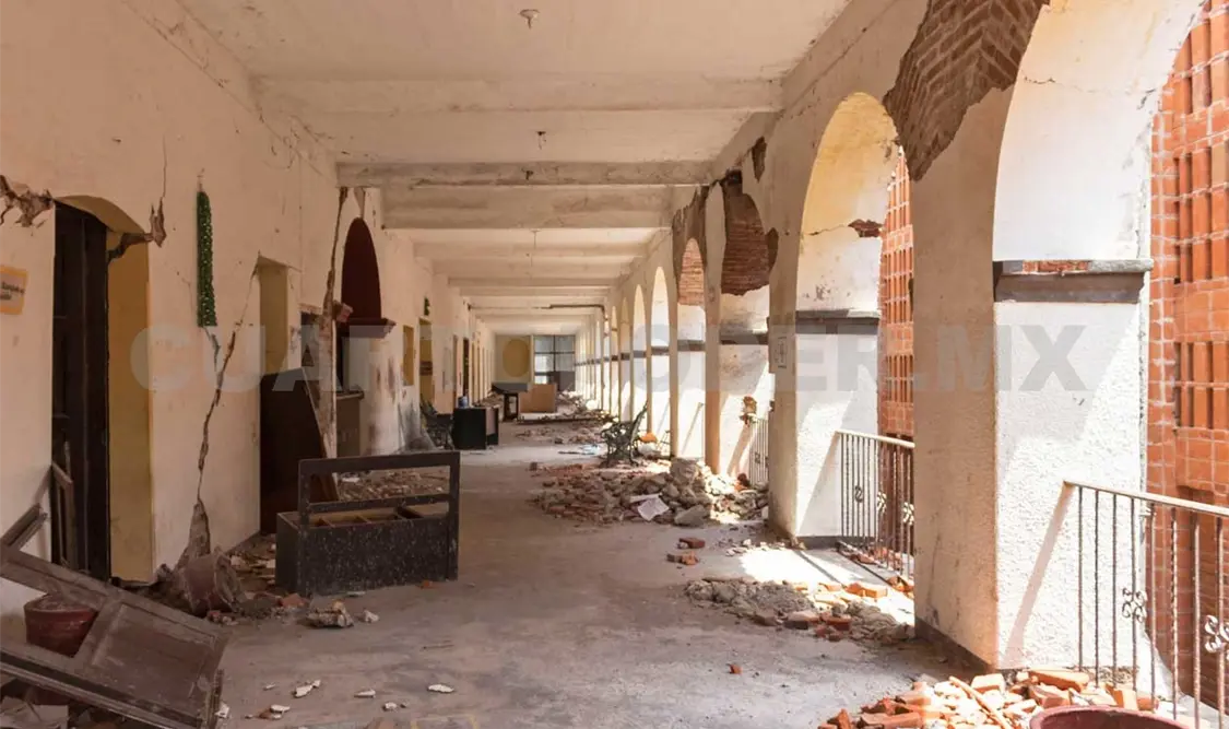 Al interior del recinto se observan muebles de oficina y escombro de los muros afectados. El Universal