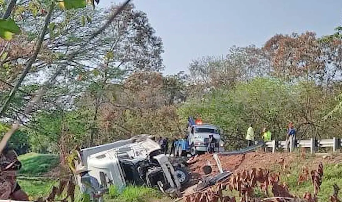 La pesada unidad terminó con las llantas al aire, luego de sufrir la salida del camino sobre el tramo Pijijiapan-Mapastepec. Víctor Sánchez / CP