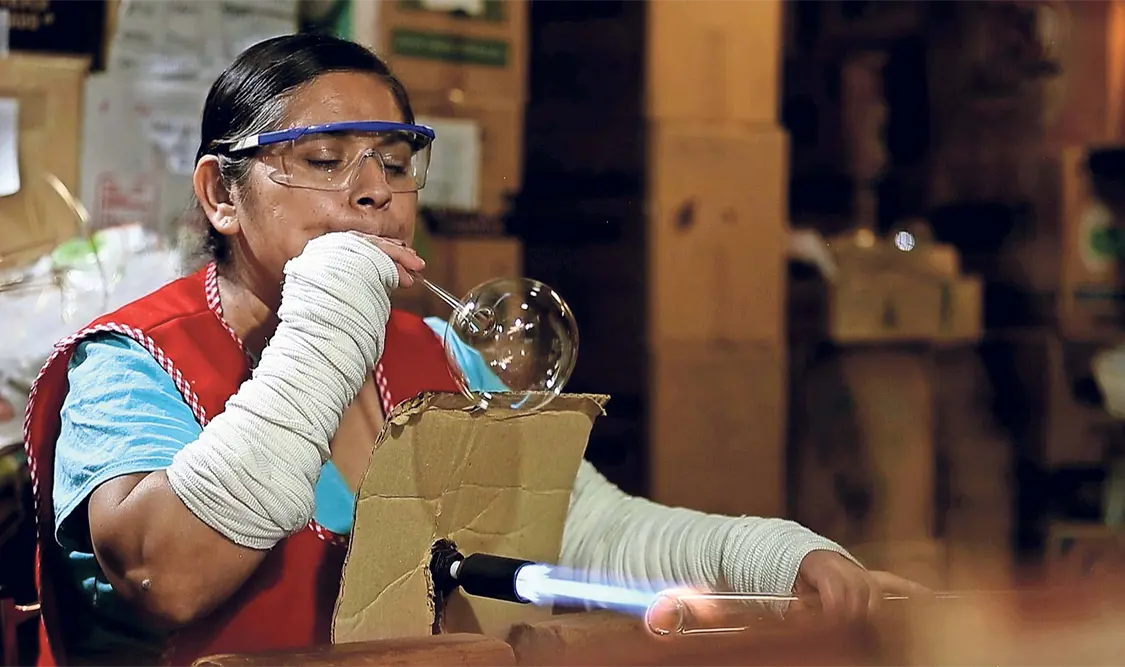 Con un soplo, Josefina Aguilar Rico da la forma esférica a los tubos de cristal que son calentados a más de 200 grados Celsius. El Universal
