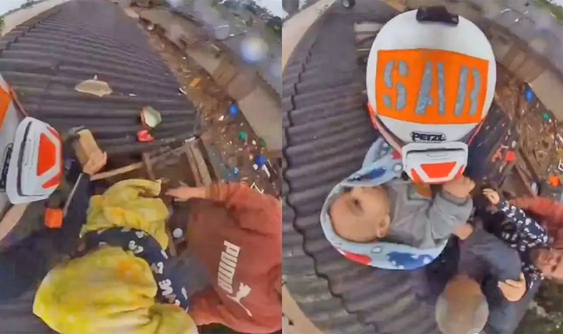 Uno de los militares bajó al tejado de la casa para rescatar al bebé. Cortesía