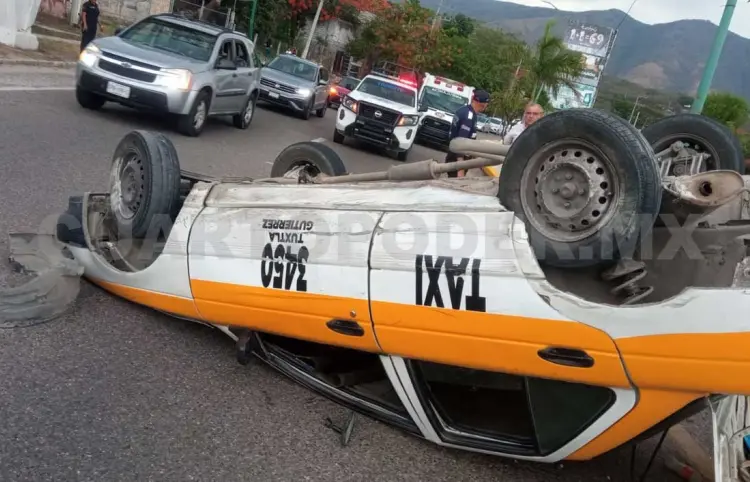Vuelca taxi en la curva de El Migrante
