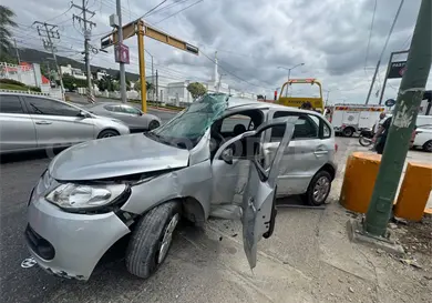Acaba prensado al colisionar en un muro de contención