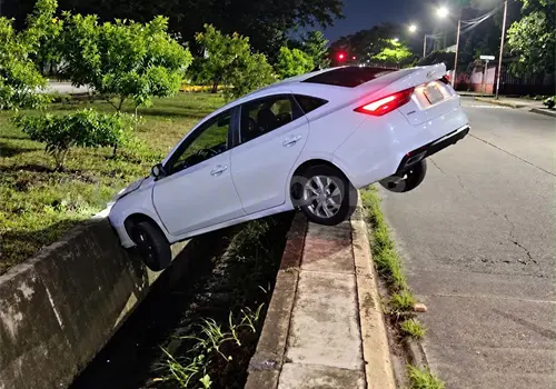 Abandonan veh&iacute;culo al caer a dren pluvial